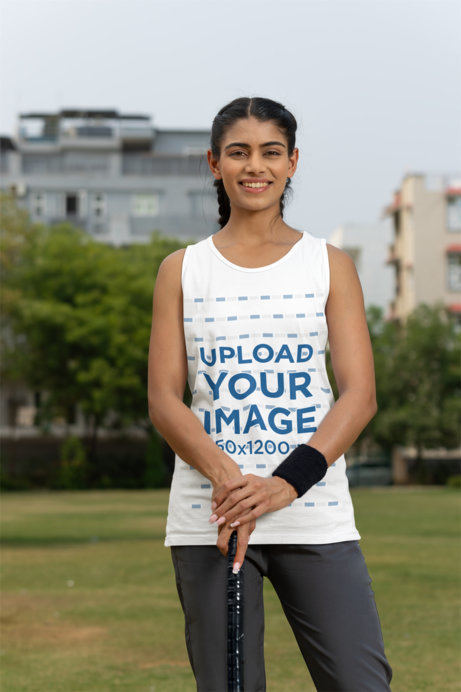 Mockup of a Smiling Woman Wearing a Tank Top on a Cricket Field