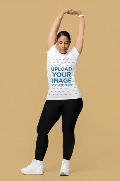 Bella Canvas T-Shirt Mockup of a Woman Stretching Her Hands in a Studio