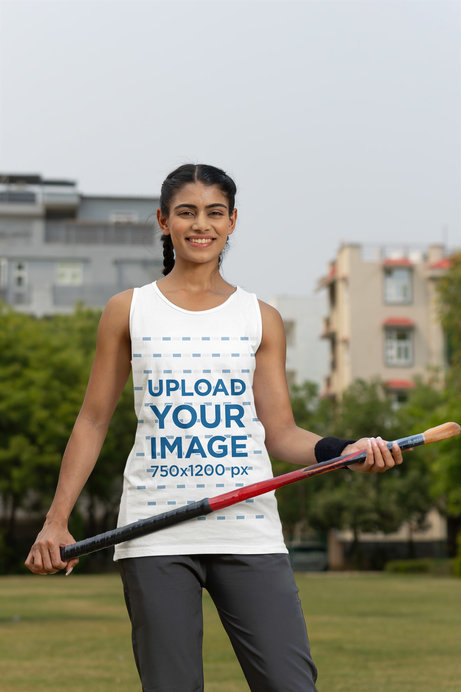 Tank Top Mockup Featuring a Happy Woman Holding a Cricket Bat