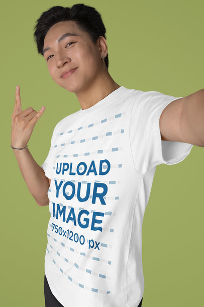 Bella Canvas T-Shirt Mockup of a Man Taking a Selfie Doing a Rock Hand Sign