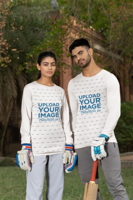 Mockup of a Man and a Woman Wearing Bella Canvas Long Sleeve Tees in a Cricket Field