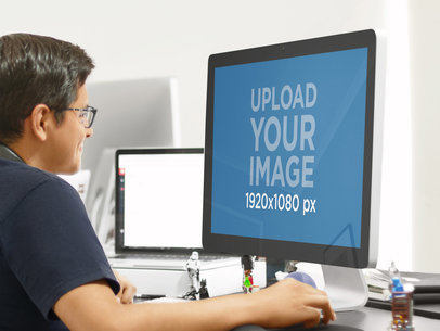 Smart Young Man Using a Mac Thunderbolt at a Modern Office