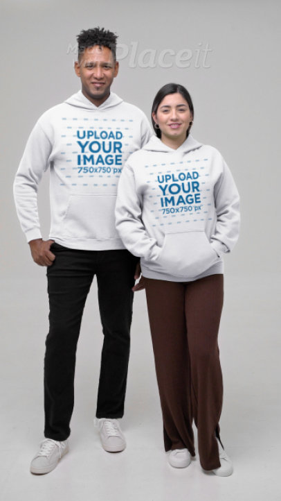 Gildan Pullover Hoodie Video Featuring a Sweet Couple Standing in a Studio 7473v
