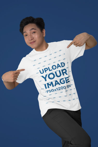Bella Canvas Mockup Featuring a Smiling Man Pointing at His T-Shirt in a Studio