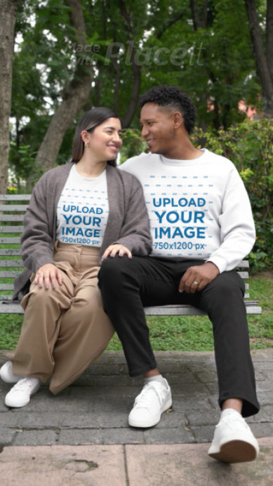 Gildan Sweatshirt Video Featuring a Happy Couple Sitting on a Park Bench
