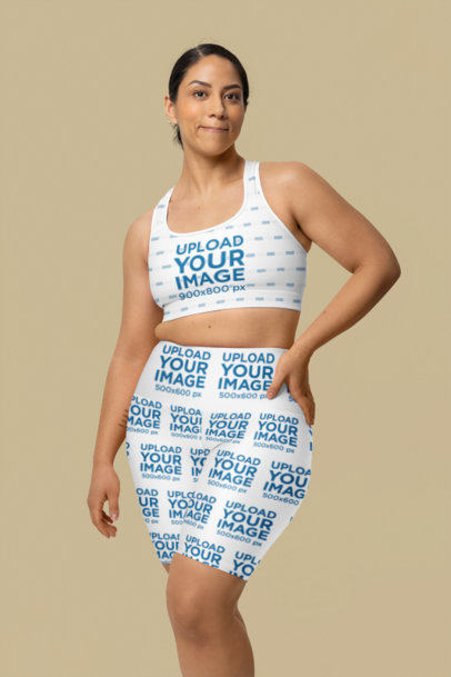 High-Waisted Yoga Shorts Mockup Featuring a Woman Posing in a Studio With a Sports Bra m40164