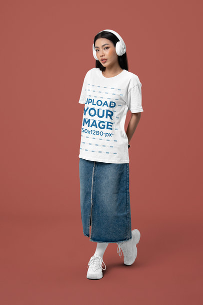 Oversized Bella Canvas Tee Mockup of a Woman Posing in a Studio With Headphones