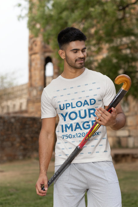 Mockup Featuring a Man Wearing a Crewneck T-Shirt Holding a Cricket Bat