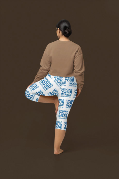 Back-View Yoga Capri Leggings Mockup of a Woman Lifting a Leg