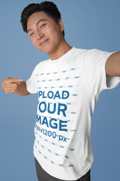 Selfie Mockup of a Happy Man in a Studio Pointing at His Crewneck Tee
