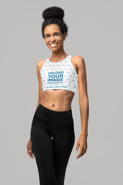 Fully Lined Sports Bra Mockup Featuring a Cheerful Woman Posing in a Studio With Activewear Clothes