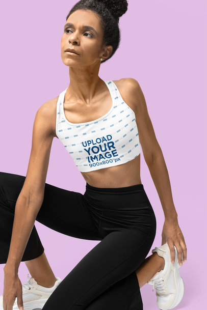 Sports Bra Mockup Featuring a Serious Woman Stretching for a Wellness Class