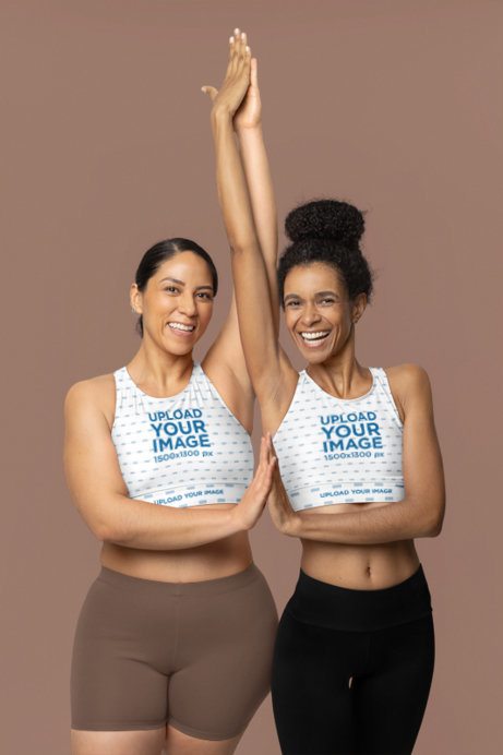 Fully Lined Sports Bra Mockup of Two Joyful Women Stretching Together
