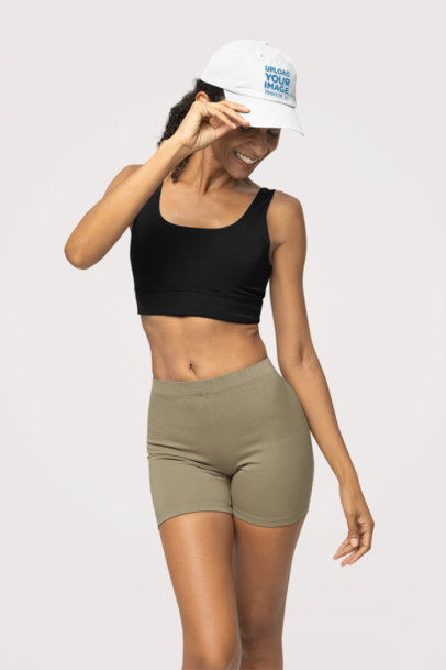 Mockup of a Joyful Woman Holding Her Otto Cap Dad Hat in a Studio