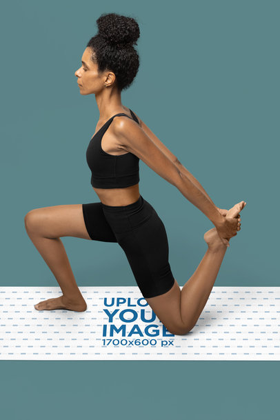 Yoga Mat Mockup Featuring a Serious Woman Stretching in a Studio