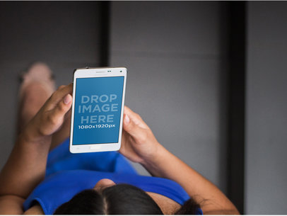 Mockup of a Lady Using a Galaxy Note 4 at the Staircase