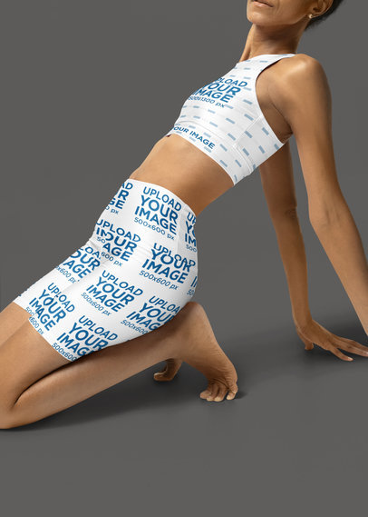 Yoga Shorts and Fully Lined Sports Bra Mockup Featuring a Woman Stretching Her Back