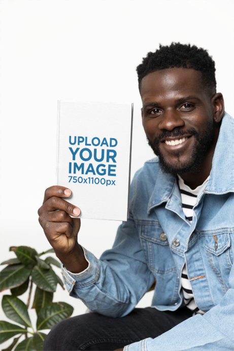 Hardcover Book Mockup Featuring a Smiling Bearded Man With a Denim Jacket
