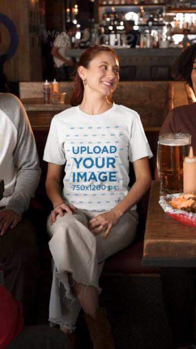 Bella Canvas T-Shirt Video Featuring a Smiling Woman Enjoying Her Time With Friends in a Sports Bar