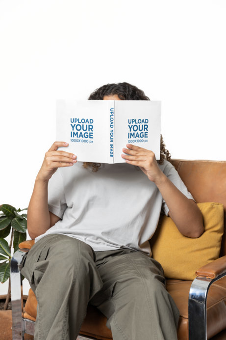 Mockup of a Woman Hiding Her Face Behind a Hardcover Book