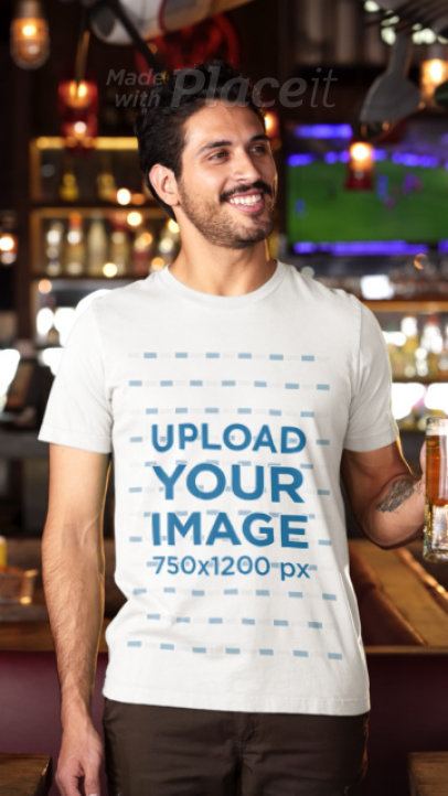 Bella Canvas T-Shirt Video of a Happy Bearded Man With a Beer in a Sports Bar