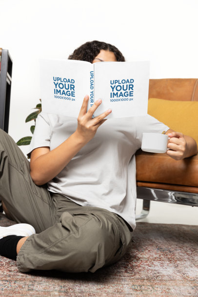 Mockup of a Curly-Haired Woman Reading a Book While Sitting on the Floor m40280