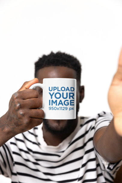 Mockup of a Man Covering His Face Behind a Coffee Mug While Taking a Selfie m40262