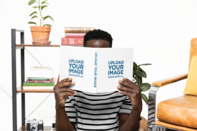 Print Mockup Featuring a Man Covering Himself Behind a Book m40275