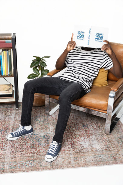 Mockup of a Man Covering His Face With a Hardcover Book While Sitting on a Couch