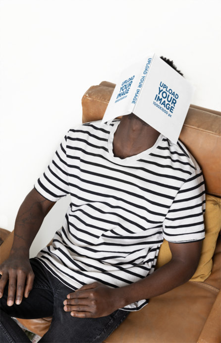 Mockup of Tired Man Covering His Face With a Squared Hard Cover Book