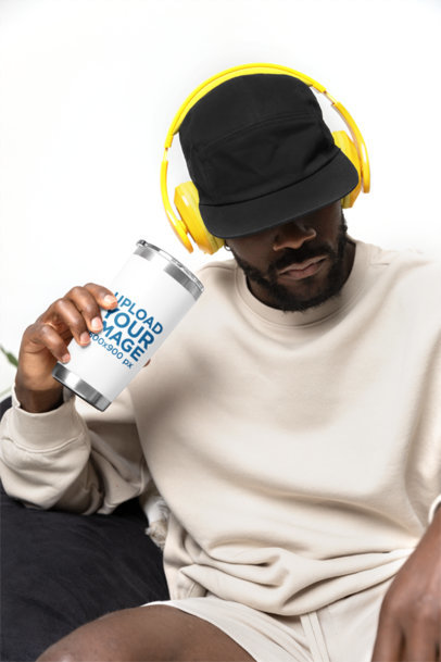 Travel Mug Mockup Featuring a Bearded Serious Man Using Headphones m40307