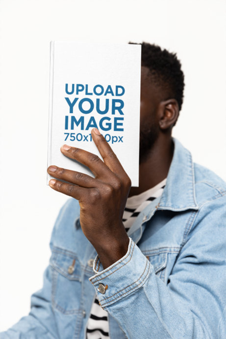 Mockup of a Man Covering His Face With a Hardcover Book in a Studio