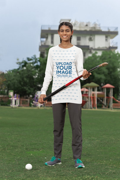 Bella Canvas Long Sleeve T-Shirt Mockup of a Happy Woman Holding a Field Hockey Bat m40007