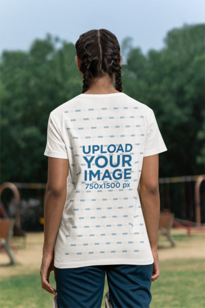 Back-View T-Shirt Mockup of a Woman Standing in a Cricket Field m39978