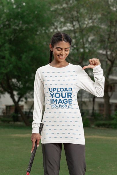 Cricket-Themed Mockup of a Woman Pointing at Her Bella Canvas Long Sleeve T-Shirt m39958