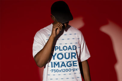 T-Shirt Mockup Featuring a Man Standing in the Middle of the Spotlight m50047