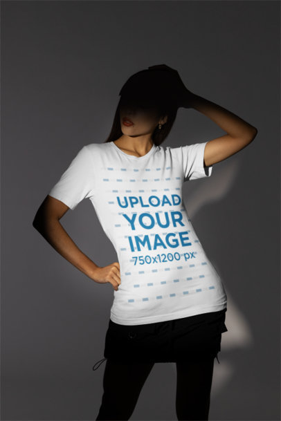Bella Canvas T-Shirt Mockup of a Woman Standing in the Spotlight of a Studio m50024