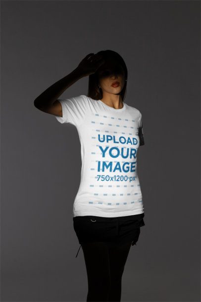 Mockup of a Woman Wearing a T-Shirt from Bella Canvas Inside a Studio