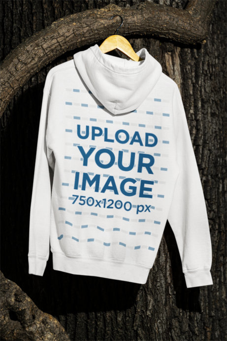 Back-View Mockupo of a Gildan Hoodie Hanging from a Tree at Night
