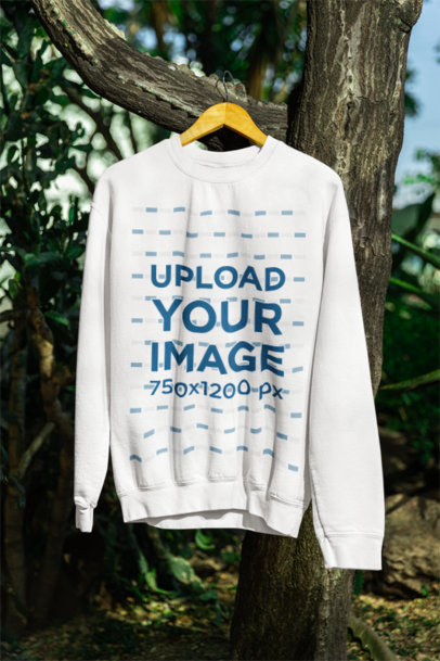 Mockup of a Gildan Round-Neck Sweatshirt Hanging from a Tree Branch m39853