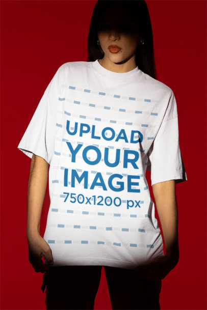 Oversized T-Shirt Mockup of a Woman Standing in a Studio with a Shaded Face m50036