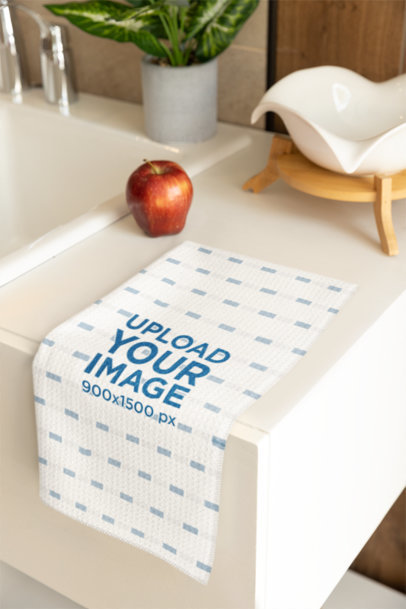 Print Mockup Featuring a Microfiber Tea Towel Placed on a Kitchen Table With an Apple m40746