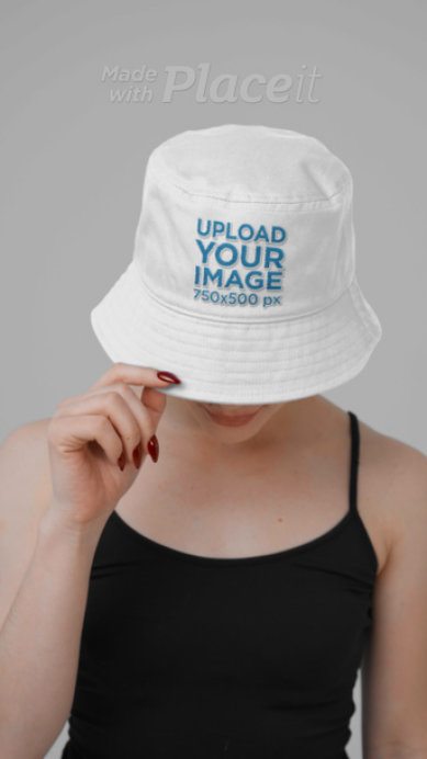 Video of a Woman Covering Her Face With an Embroidered Bucket Hat