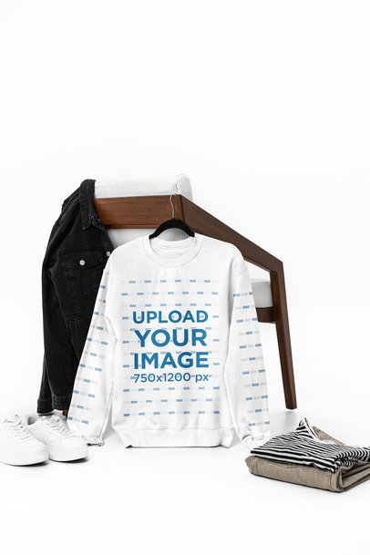 Mockup of a Gildan Crewneck Sweatshirt Hanging From a Wooden Chair m39775