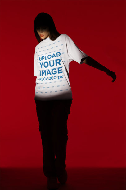 Mockup of a Woman Wearing a Round-Neck Tee in the Spotlight of a Studio m50039