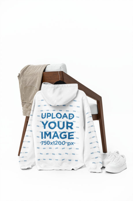 Mockup of the Back-View of a Gildan Pullover Hoodie Hanging on a Chair