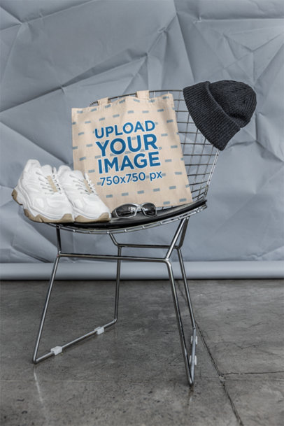 Mockup of a Tote Bag Placed on a Chair With a Pair of Sneakers and Sunglasses m39780