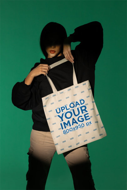 Mockup Featuring a Woman Posing with a Tote Bag in a Studio m50041