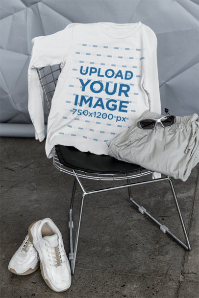 Apparel Mockup Featuring a Bella Canvas Long-Sleeve Tee Lying on a Chair With Some Garments m39761