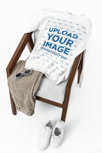 Gildan Mockup Featuring a Sweatshirt Lying on a Chair With a Pair of Sunglasses m39776